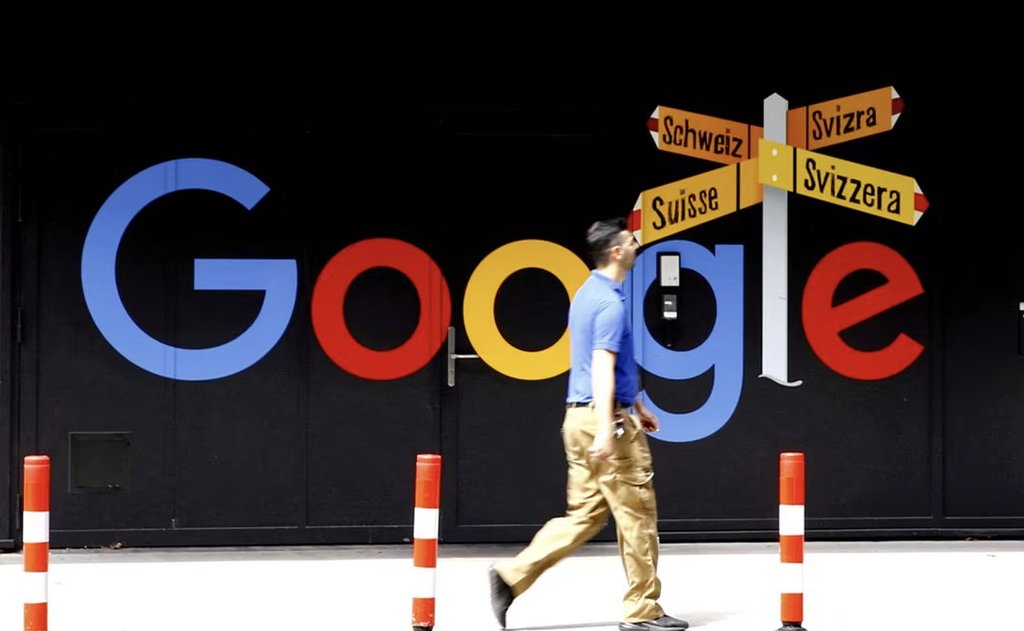 Một Người Đàn Ông Đi Qua Logo Google Trước Một Tòa Nhà Văn Phòng Ở Zurich, Thụy Sĩ. Ảnh: Reuters